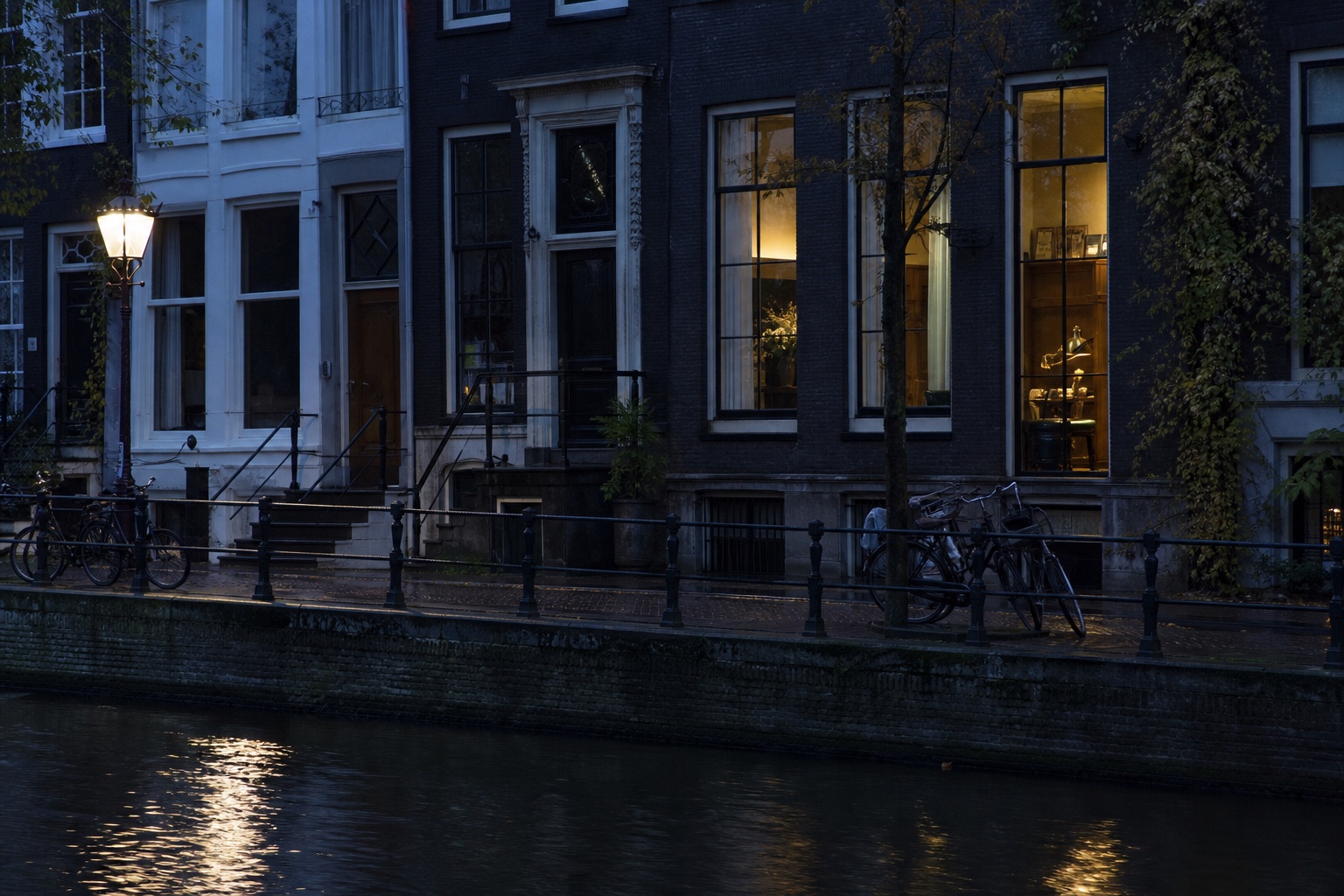 Amsterdam canal houses and bicycles at blue hour